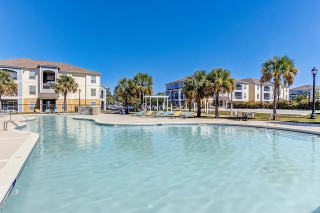 Resort style pool and lounge chairs exterior at Cambridge @ Southern - The Palms in Statesboro Student Accommodation