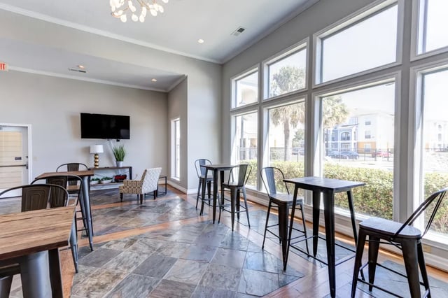 High tables and chairs with large windows. at Cambridge @ Southern - The Palms in Statesboro Student Accommodation