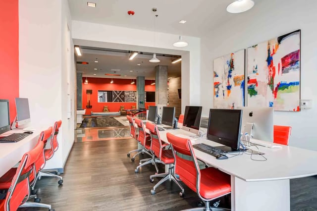 Computers and red chairs computer lab at LUX on Capitol in Indianapolis Student Accommodation