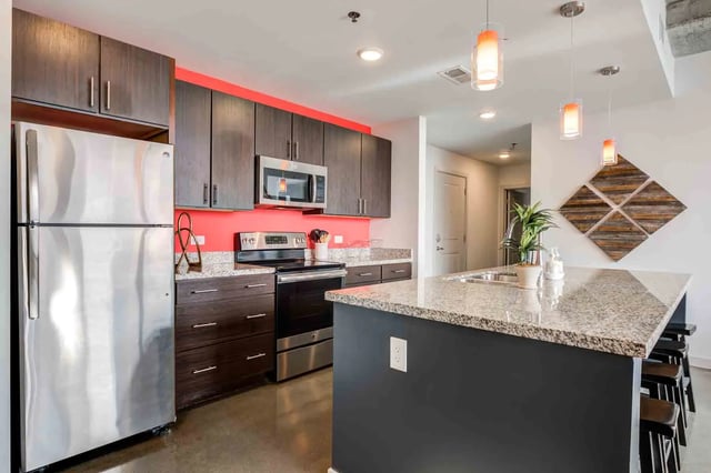 Refrigerator stove cabinets island with sink kitchen at LUX on Capitol in Indianapolis Student Accommodation