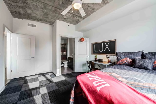 Bed with desk and chalkboard Bedroom at LUX on Capitol in Indianapolis Student Accommodation
