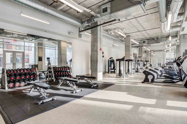 Dumbbell racks weight benches and cardio machines gym at LUX on Capitol in Indianapolis Student Accommodation