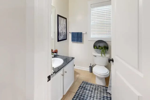 Sink toilet framed art towel rug bathroom at College Town Oxford in Oxford Student Accommodation