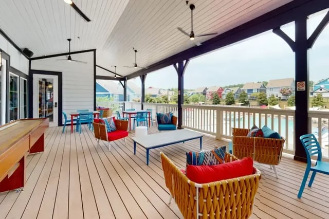 Shuffleboard table chairs tables pool view exterior at College Town Oxford in Oxford Student Accommodation