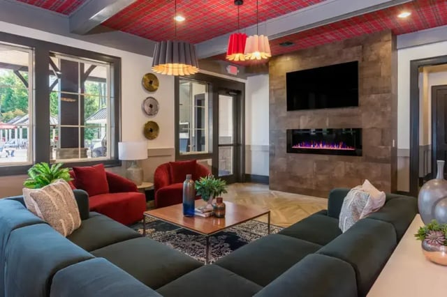 Spacious living room with sectional fireplace and TV at College Town Oxford in Oxford Student Accommodation