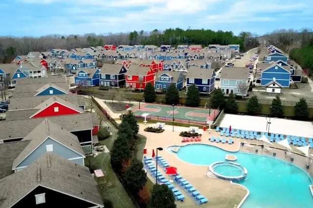 Colorful houses surrounding pool and basketball court exterior at College Town Oxford in Oxford Student Accommodation