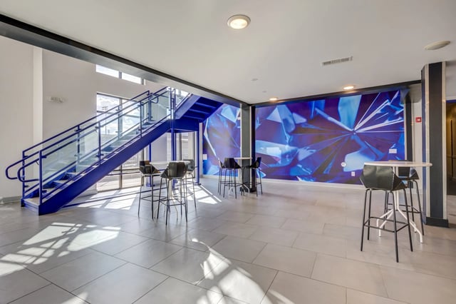 Staircase bar stools and modern mural communal area at Ion Baton Rouge in Baton Rouge Student Accommodation