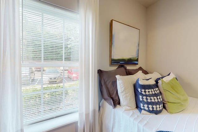Bed with pillows artwork and window bedroom at The Quarters at Oxford in Oxford Student Accommodation