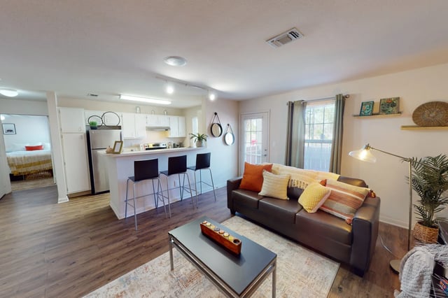 Brown couch kitchen island and bedroom living area at The Quarters at Lincoln in Lincoln Student Accommodation