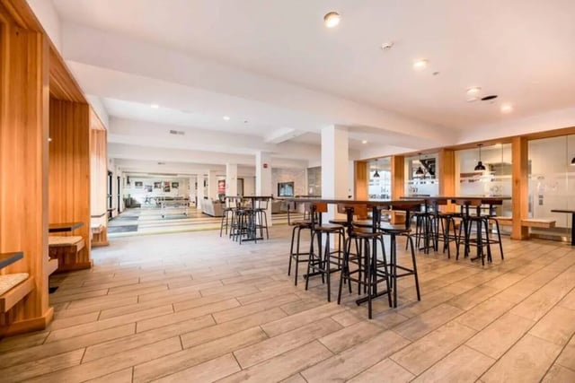 Wooden booths bar tables and stools common area at T-H-E Griff in Columbus Student Accommodation