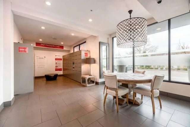Package lockers table chairs chandelier communal area at T-H-E Griff in Columbus Student Accommodation