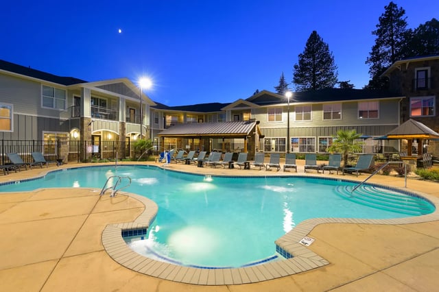 Pool with loungers and buildings exterior at The Retreat at Corvallis in Corvallis Student Accommodation