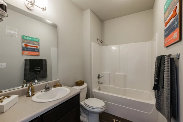 Sink toilet bathtub shower and decor bathroom at The Quarters at Stillwater in Stillwater Student Accommodation