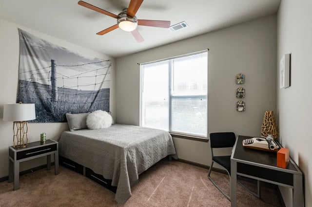 Bed desk lamp window and fan bedroom at The Quarters at Stillwater in Stillwater Student Accommodation