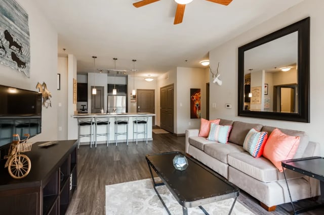 Sofa coffee table and kitchen island living room at The Quarters at Stillwater in Stillwater Student Accommodation