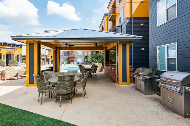 Outdoor pavilion with dining tables grills and pool at The Quarters at Stillwater in Stillwater Student Accommodation