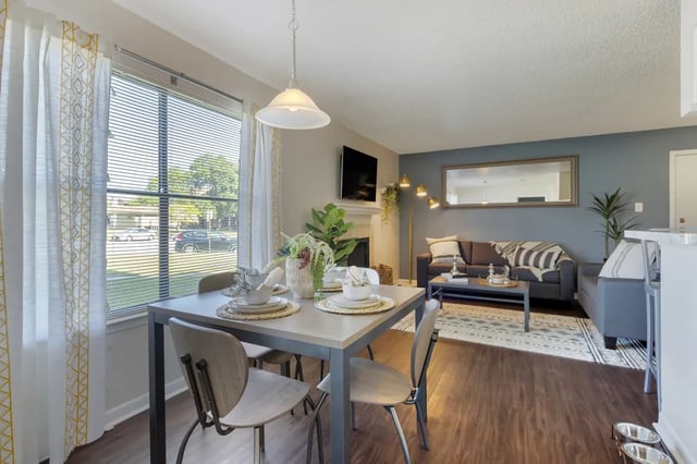 Dining table with chairs and living room living room at The Landing at College Station in College Station Student Accommodation