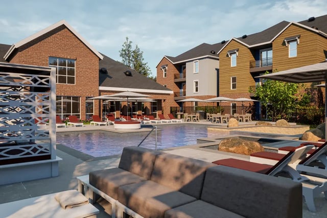 Pool lounge chairs umbrellas and seating area exterior at The Landing at College Station in College Station Student Accommodation