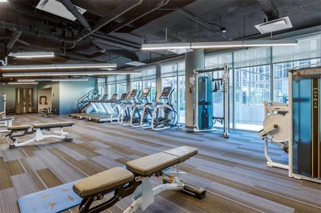 Treadmills weight machines benches gym area at Rise At Riverfront Crossings in Iowa City Student Accommodation