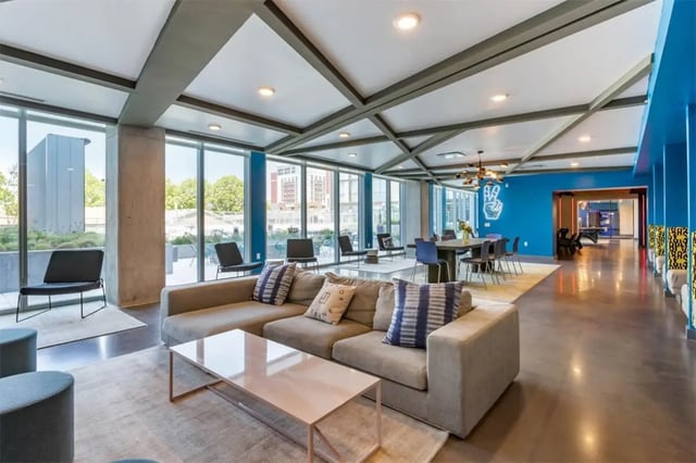 Modern living room with sofa dining table and chairs living room at Rise At Riverfront Crossings in Iowa City Student Accommodation