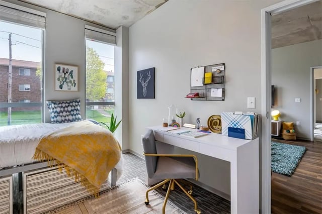 Bed desk chair and filing cabinet bedroom at Rise At Riverfront Crossings in Iowa City Student Accommodation