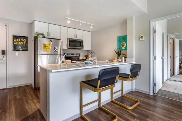 Modern kitchen with island and stools kitchen at Rise At Riverfront Crossings in Iowa City Student Accommodation
