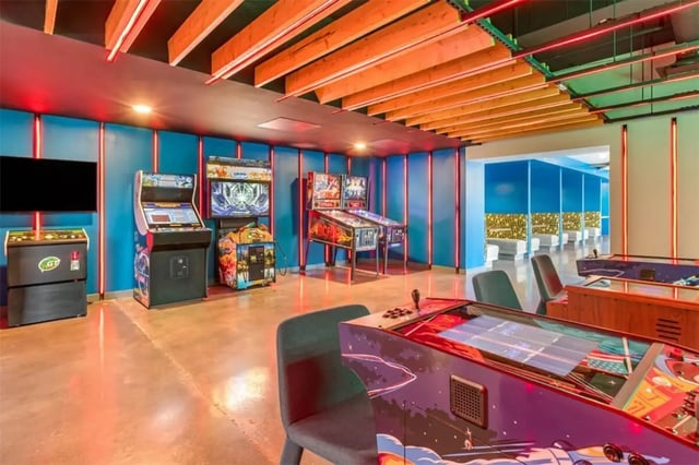 Arcade machines pinball and TV playing area at Rise At Riverfront Crossings in Iowa City Student Accommodation