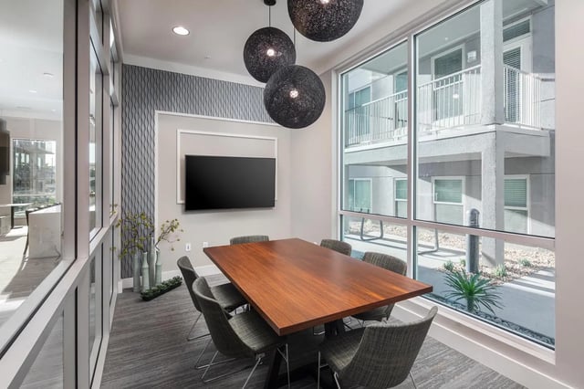 Wood table chairs tv modern decor meeting room at The Mark at Tucson in Tucson Student Accommodation