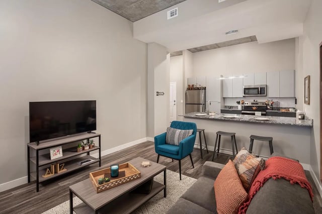 TV coffee table chair kitchen counter living room at The Mark at Tucson in Tucson Student Accommodation