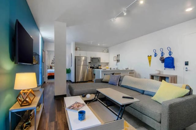 Sofa kitchen island television and coffee table living room at Rise On 9th in Columbia Student Accommodation