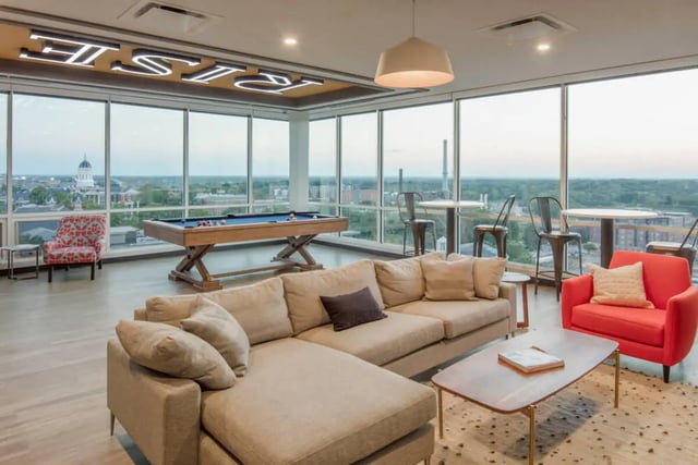 Pool table sectional sofa red chair living room at Rise On Chauncey in West Lafayette Student Accommodation