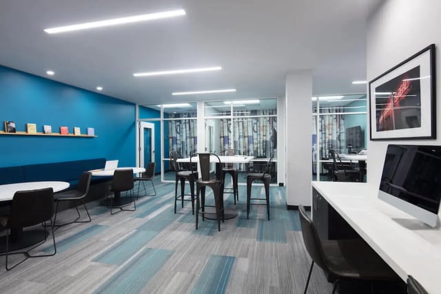 Modern lounge area with tables chairs and computers lounge at Rise On Chauncey in West Lafayette Student Accommodation
