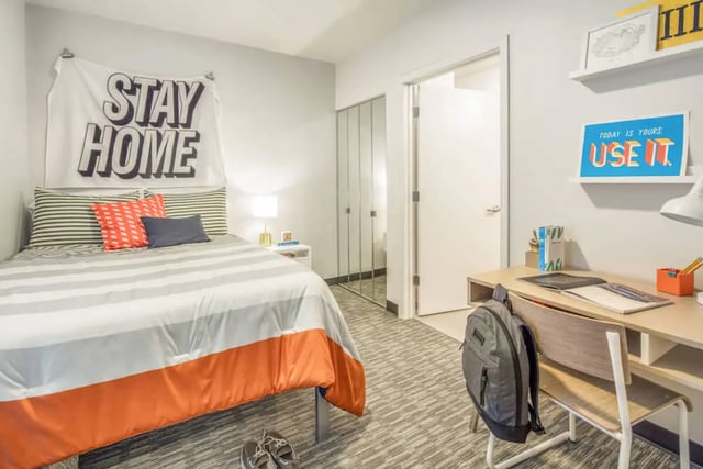 Bed with desk and backpack Bedroom at Rise On Chauncey in West Lafayette Student Accommodation