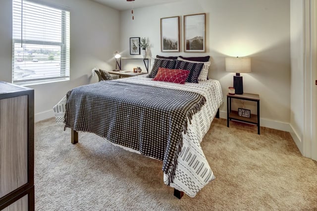 Bed desk lamp and framed art bedroom at The Retreat at Denton in Denton Student Accommodation