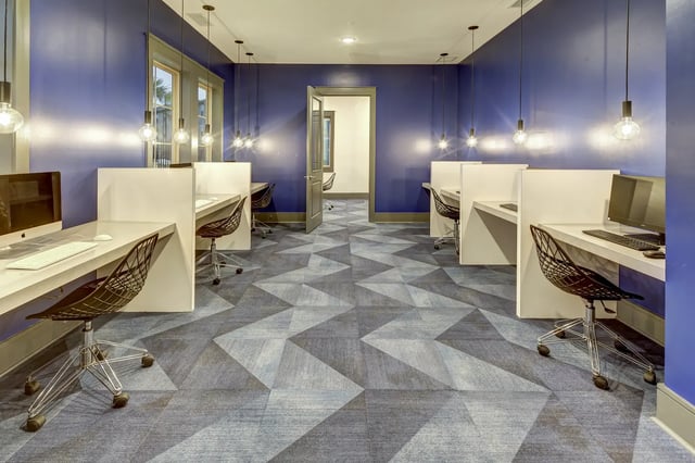 Desks computers chairs geometric carpet study area at The Retreat at Denton in Denton Student Accommodation