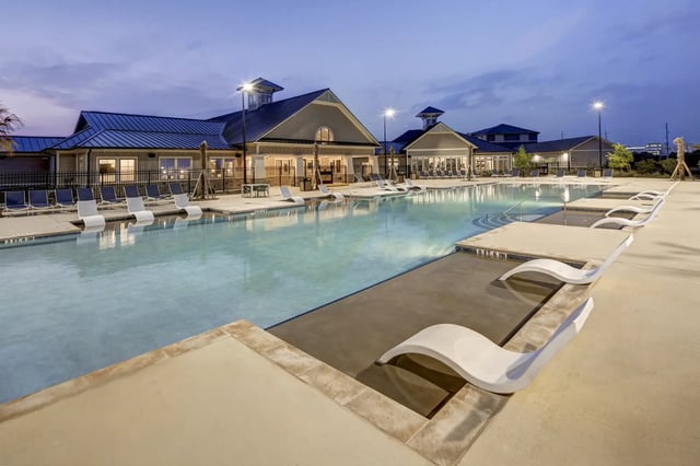 Swimming pool with lounge chairs exterior at The Retreat at Denton in Denton Student Accommodation