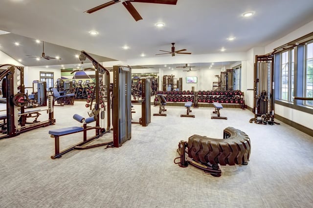 Gym with weight machines dumbbells and tire gym at The Retreat at Denton in Denton Student Accommodation