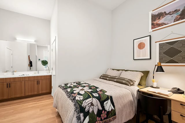 Bed and vanity area student accommodation bedroom at Identity Davis Apartments in Davis Student Accommodation