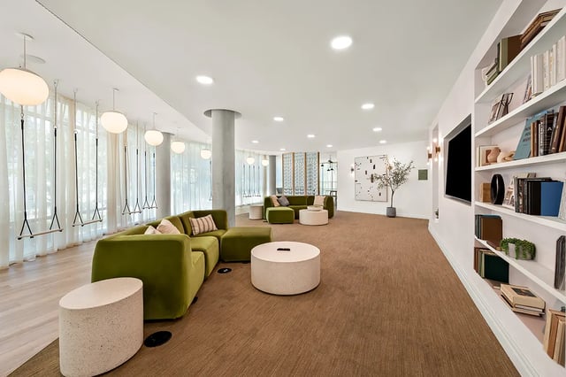 Modern lounge with swings sofas and a TV area. at Identity Davis Apartments in Davis Student Accommodation