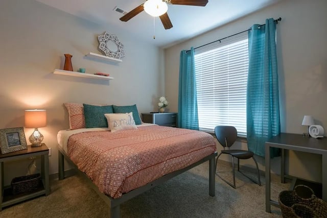 Bed desk chair mirror window bedroom at The Standard in St. Louis Student Accommodation