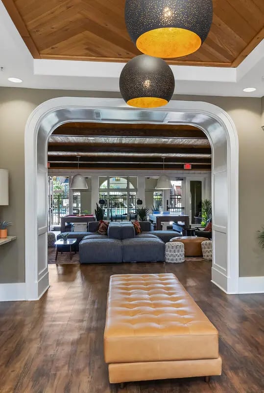 Leather ottoman and couches in lounge area at Tradition at 777 in Baton Rouge Student Accommodation