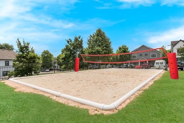 Sand volleyball court with red net exterior at Ikon in Athens Student Accommodation