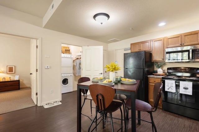 Table chairs stacked washer dryer kitchen at Irish Row in South Bend Student Accommodation