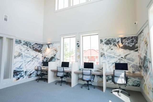 Workstations with computers and chairs study area at The Retreat at Illinois in Urbana Student Accommodation