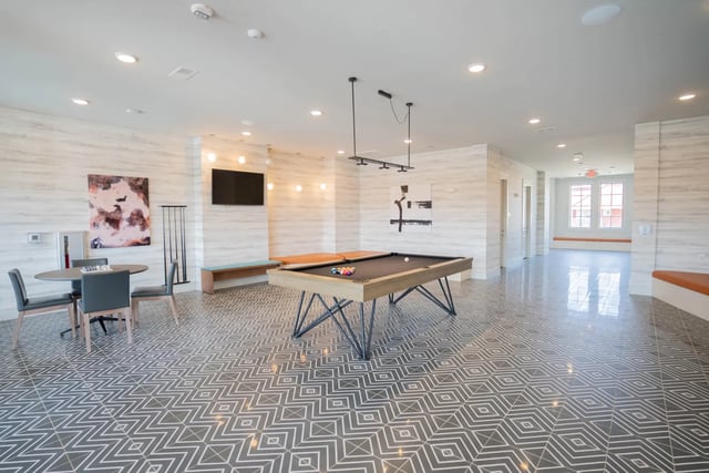 Pool table chairs television seating area lounge at The Retreat at Illinois in Urbana Student Accommodation