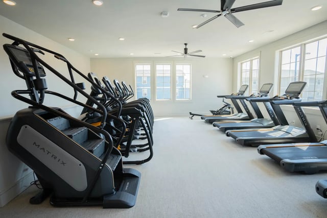 Stair climbers and treadmills in bright gym playing area at The Retreat at Illinois in Urbana Student Accommodation