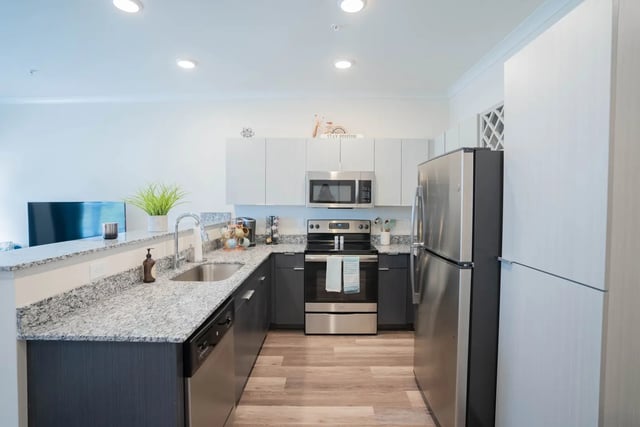 Modern kitchen with stainless steel appliances and granite countertops Kitchen at The Retreat at Illinois in Urbana Student Accommodation