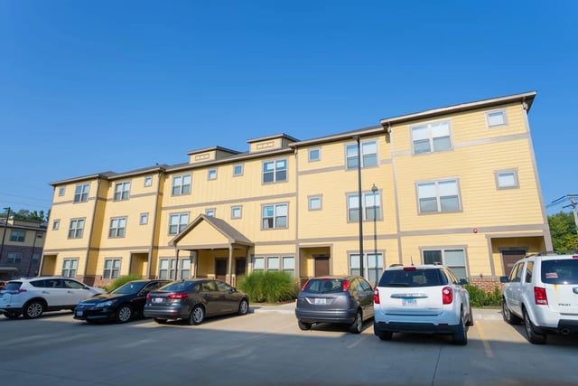 Apartment building with parking lot exterior at The Retreat at Illinois in Urbana Student Accommodation