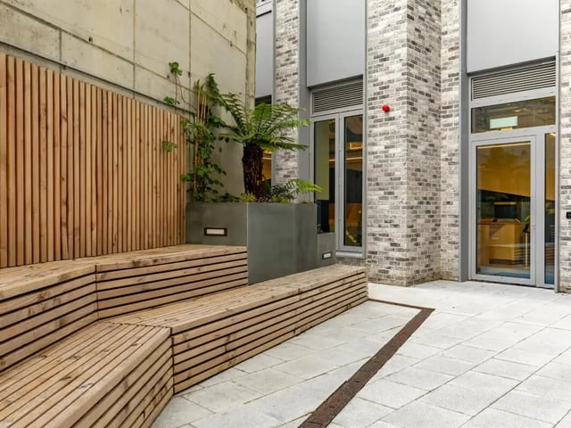 Wooden tiered seating with plants exterior at Great Court in London Student Accommodation