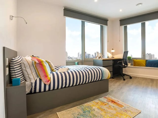 Bed desk chair and windows student bedroom at Great Court in London Student Accommodation
